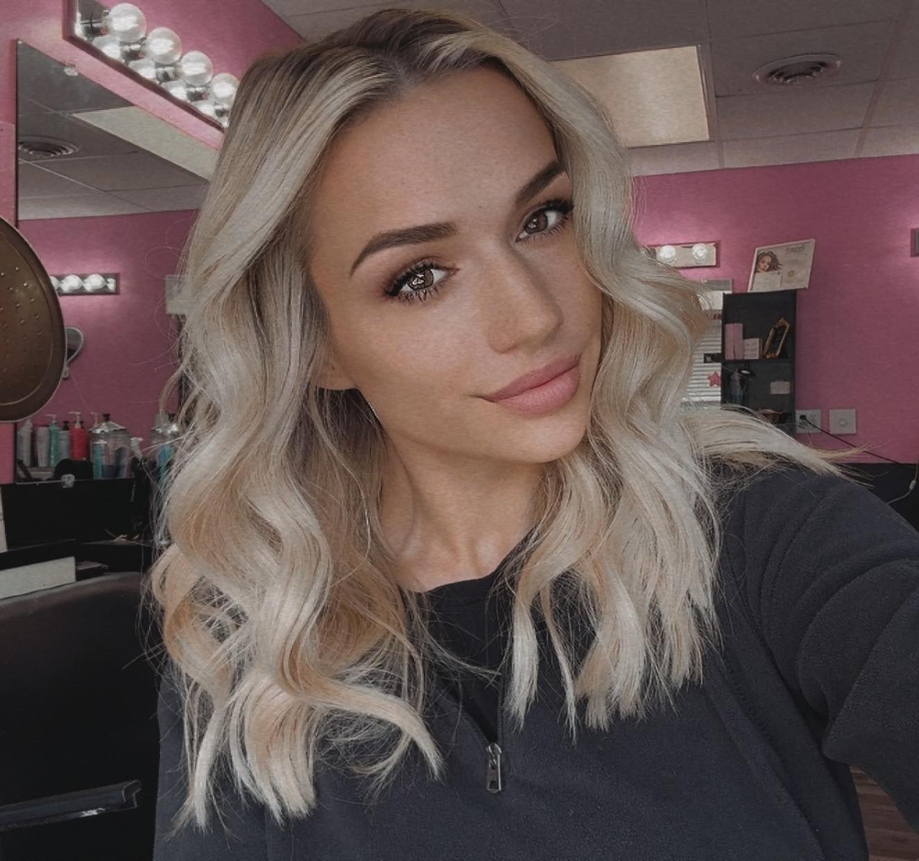 Jasmin Shawler professional hair artist portrait, smiling in salon setting showcasing her expertise in precision cuts and color artistry